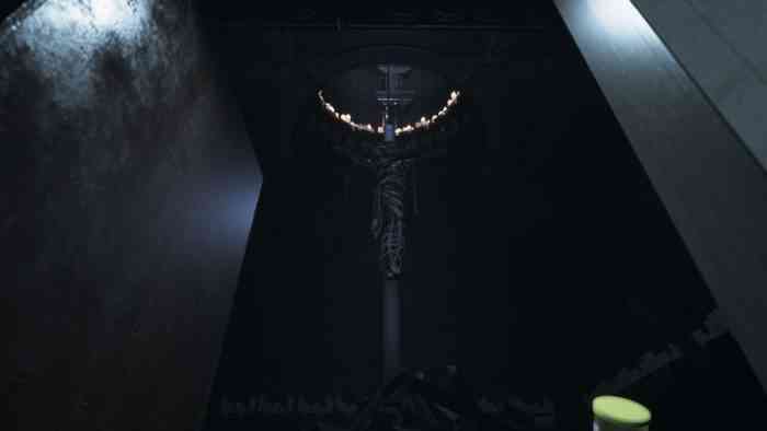 A screenshot from Visage showing a body suspended crucifixion-style below a hole ringed with candles.